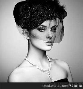 Retro portrait of a beautiful woman. Vintage style. Perfect make-up. Fashion photo. Black and white photo