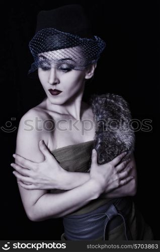 Retro portrait of a beautiful young woman in hat with veil