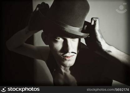 Retro portrait of a theatrical actor with a hat