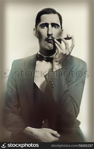 retro portrait of an adult man smoking a pipe closeup