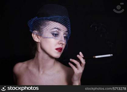 Retro portrait of beautiful young caucasian woman in veil with cigarette