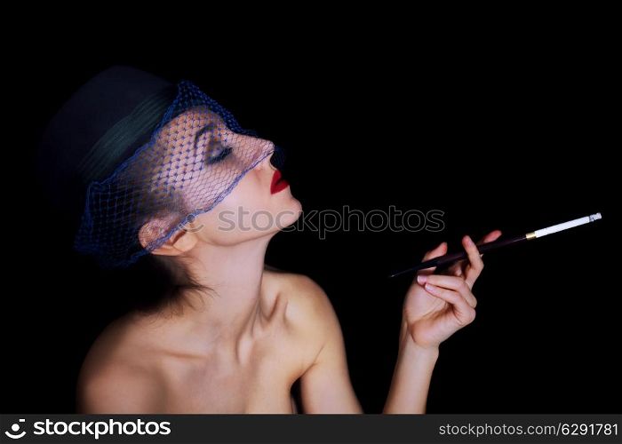 Retro portrait of beautiful young caucasian woman in veil with cigarette