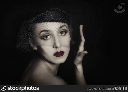 Retro portrait of beautiful young woman in veil