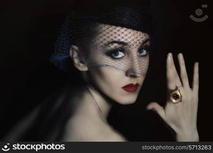 Retro portrait of beautiful young woman in veil with ring