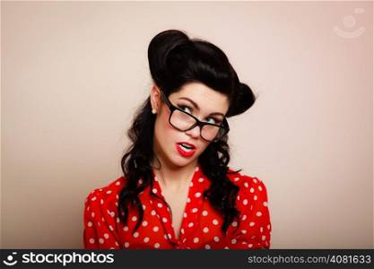Retro. Portrait of stylish young woman student or teacher in eyeglasses on pink. Brunette girl in pinup style. Education.