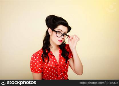 Retro. Portrait of stylish young woman student or teacher in eyeglasses on yellow. Brunette girl in pinup style. Education.