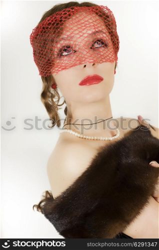 Retro portrait of young beautiful woman in veil and mink shawl with pearls on white background