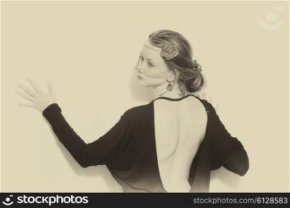 Retro portrasit of Young beautiful woman wearing veil on white background