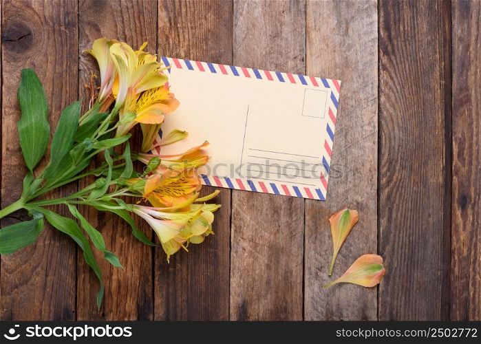 Retro postcard with flowers on vintage wooden table still life
