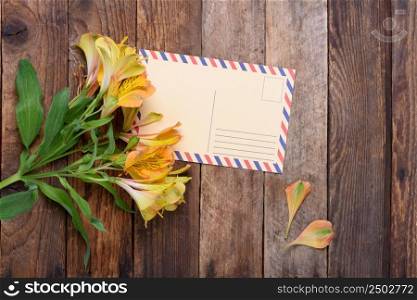Retro postcard with flowers on vintage wooden table still life