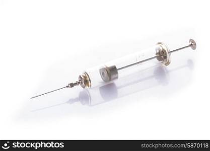 Retro reusable glass syringe on a white