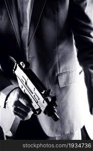 Retro secret agent with sub machine gun in hand vintage crime thriller mockup photo.
