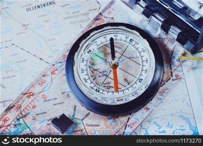 retro style abstract shoot with the compass on a map