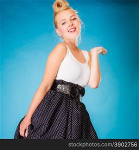 Retro style and dance pose. Blonde pin up girl dancer on blue in studio.