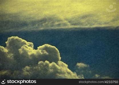 Retro style cloudscape with vintage colors and a textured paper background.