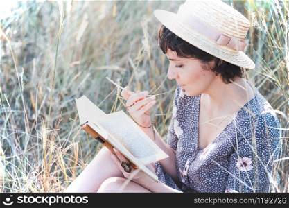 retro style. girl reads a book outdoors