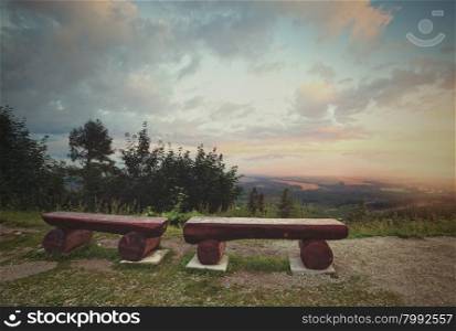 Retro style image of bench at the mountains