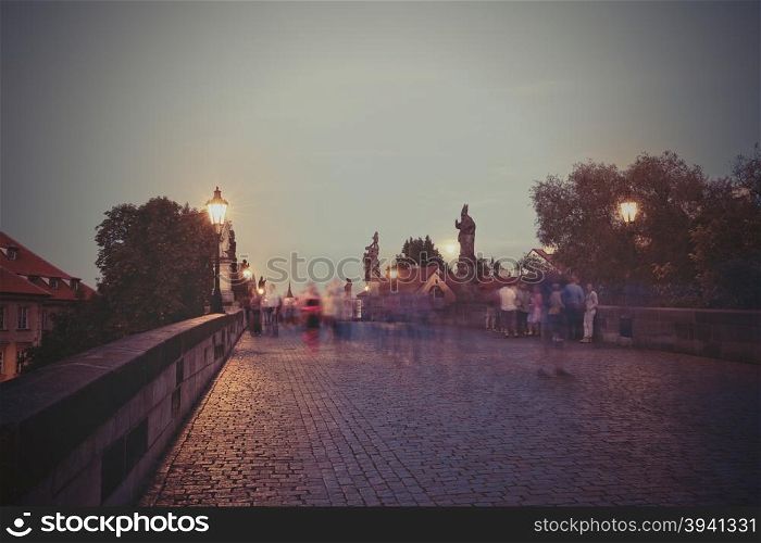 Retro style image of Charles Bridge at dusk, Prague, Czech Republic