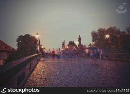 Retro style image of Charles Bridge at dusk, Prague, Czech Republic