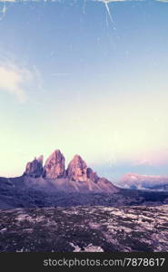 Retro style image of Tre Cime at sunrise, Italian Dolomites