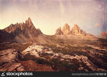 Retro style image of Tre Cime at sunrise, Italian Dolomites