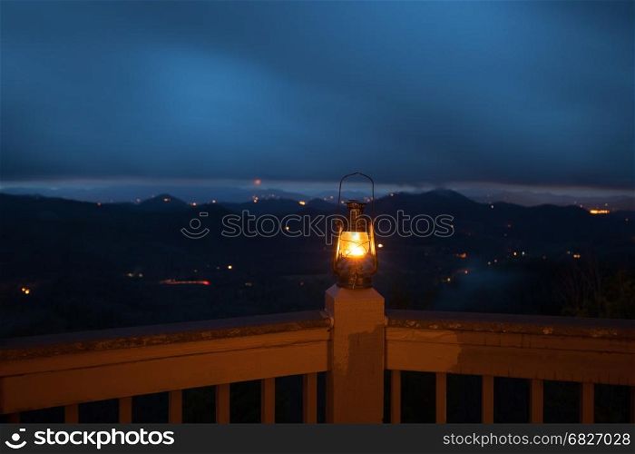 Retro style lantern over night mountain background