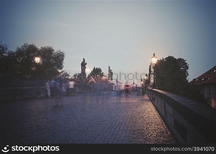 Retro style photo of Charles Bridge at dusk, Prague, Czech Republic