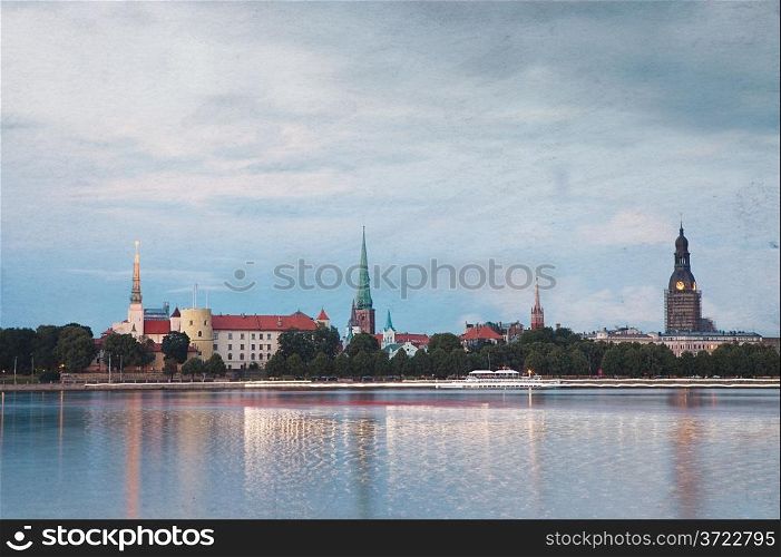 Retro style photo of night Riga cityscape. Latvia