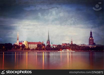 Retro style photo of night Riga cityscape. Latvia