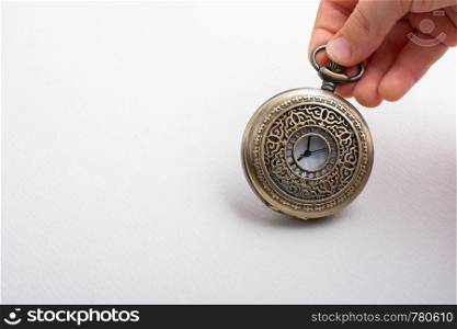 Retro style pocket watch in the hand