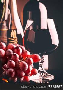 Retro style wine still life with grapes and beverages on the desk