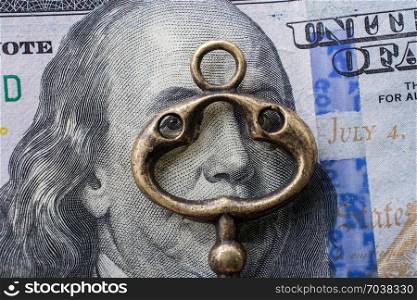 Retro styled key on US dollar banknote in view