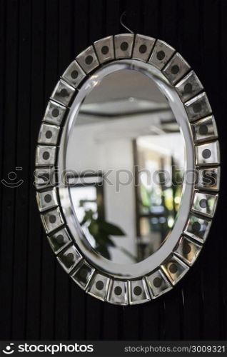 Retro styled oval mirror with room reflection, stock photo
