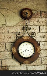Retro styled wall clock on a bricket wall