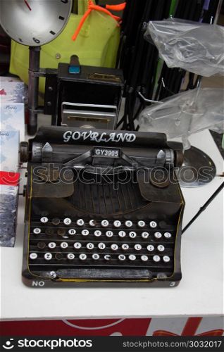 Retro syled tiny typewriter model on white background. Retro syled tiny typewriter model on a white background