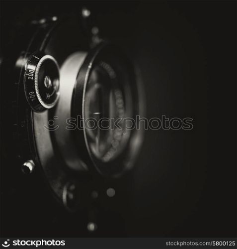 Retro view camera lens with vintage shutter, abstract techno backgrounds. Grungy texture