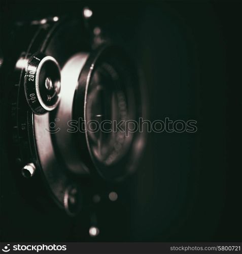 Retro view camera lens with vintage shutter, abstract techno backgrounds. Grungy texture