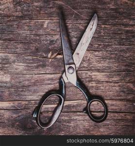 Retro vintage scissors on the wooden background. The Retro scissors