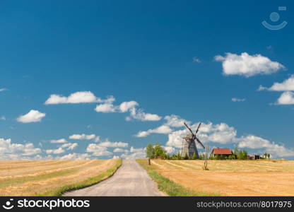 Retro windmill in a field, rural landscape