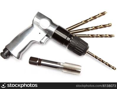 reversible air drill, set of drills and tap on white background