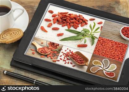 reviewing and editing pictures of goji berries on a digital tablet