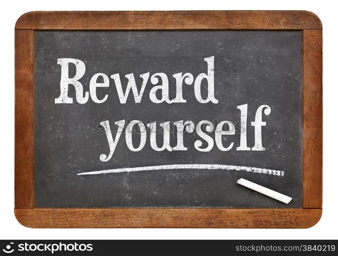 Reward yourself - motivational words on a vintage slate blackboard