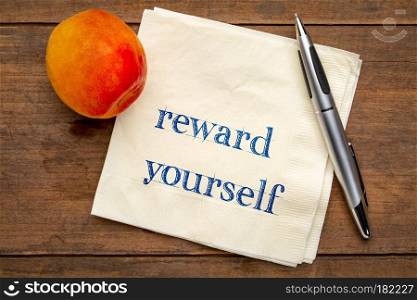 reward yourself reminder - handwriting on a napkin with a fresh apricot