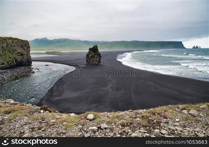 Reynisfjara Black Beach on a cloudy summer morning, Iceland.