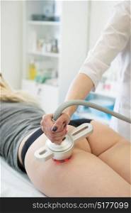 rf lifting procedure. Body treatment: woman with overweight and bad skin getting rf lifting procedure to her thighs