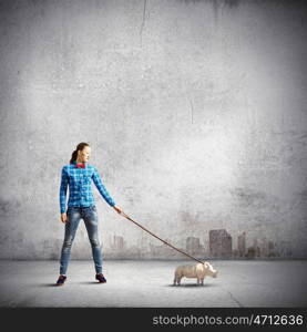 Rhino on lead. Young woman in casual holding rhino on lead