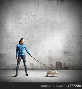 Rhino on lead. Young woman in casual holding rhino on lead