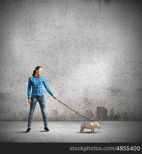 Rhino on lead. Young woman in casual holding rhino on lead