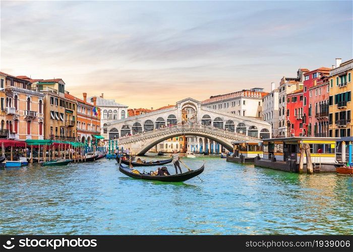 Rialto Bridge and gondoliers, a popular landmark of Venice, Italy.