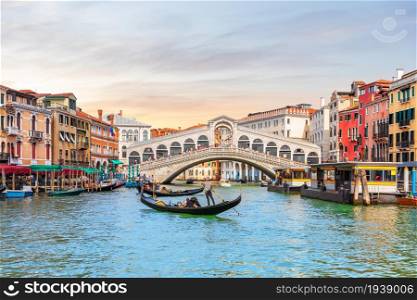 Rialto Bridge and gondoliers, a popular landmark of Venice, Italy.